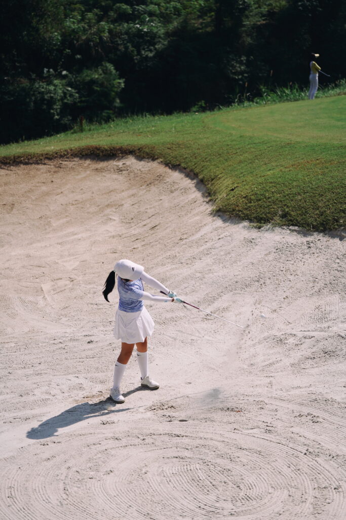 young golfer take out golf ball from a bunker
