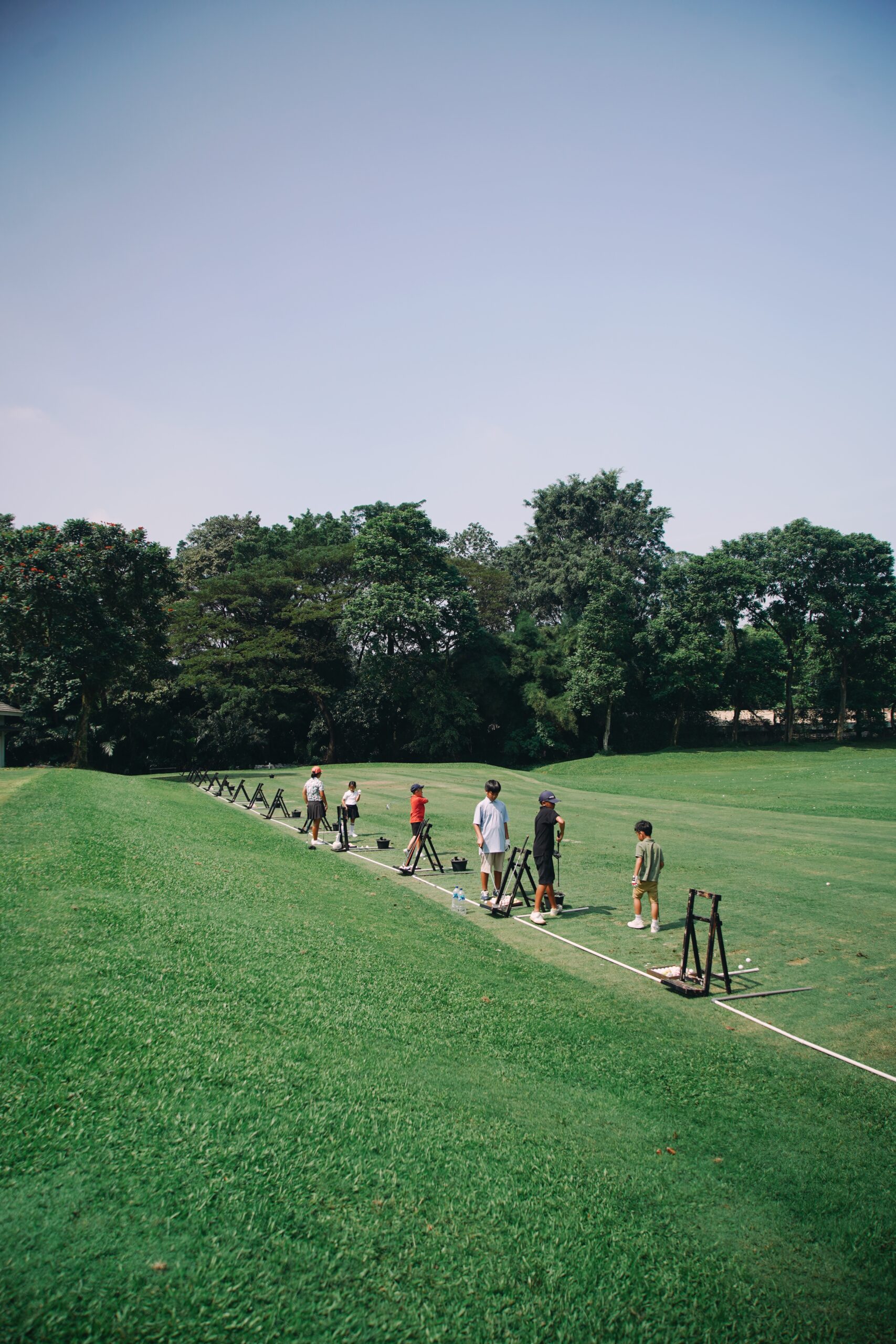 Junior golfer are trained on the driving range